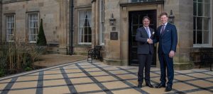 Andrew McPherson and Neil Geddes shaking hands outside Grantley Hall